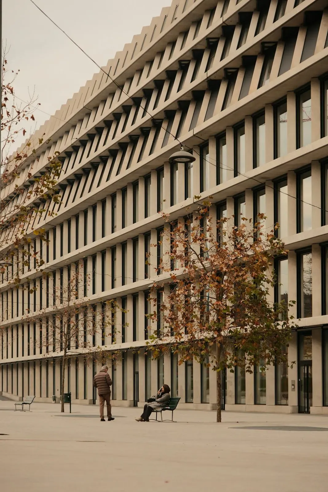 Modern concrete building facade with layered window screens