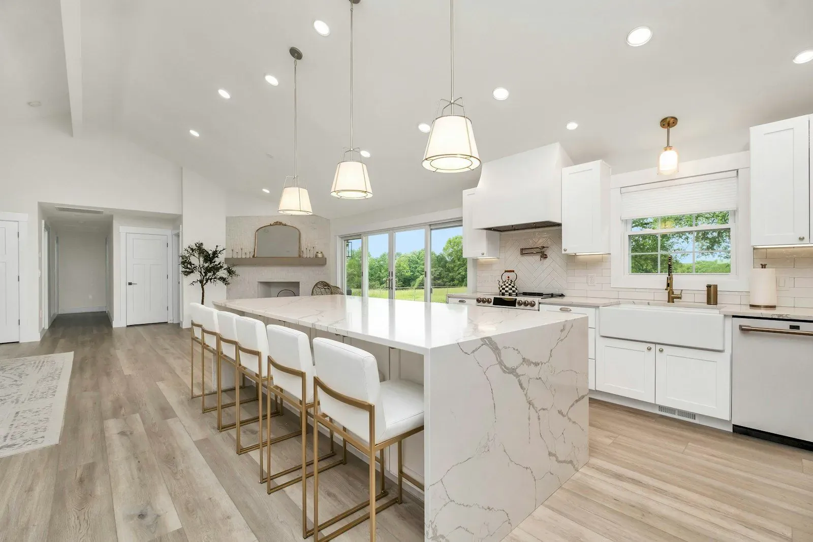 Bright modern kitchen with a marble island and white cabinets