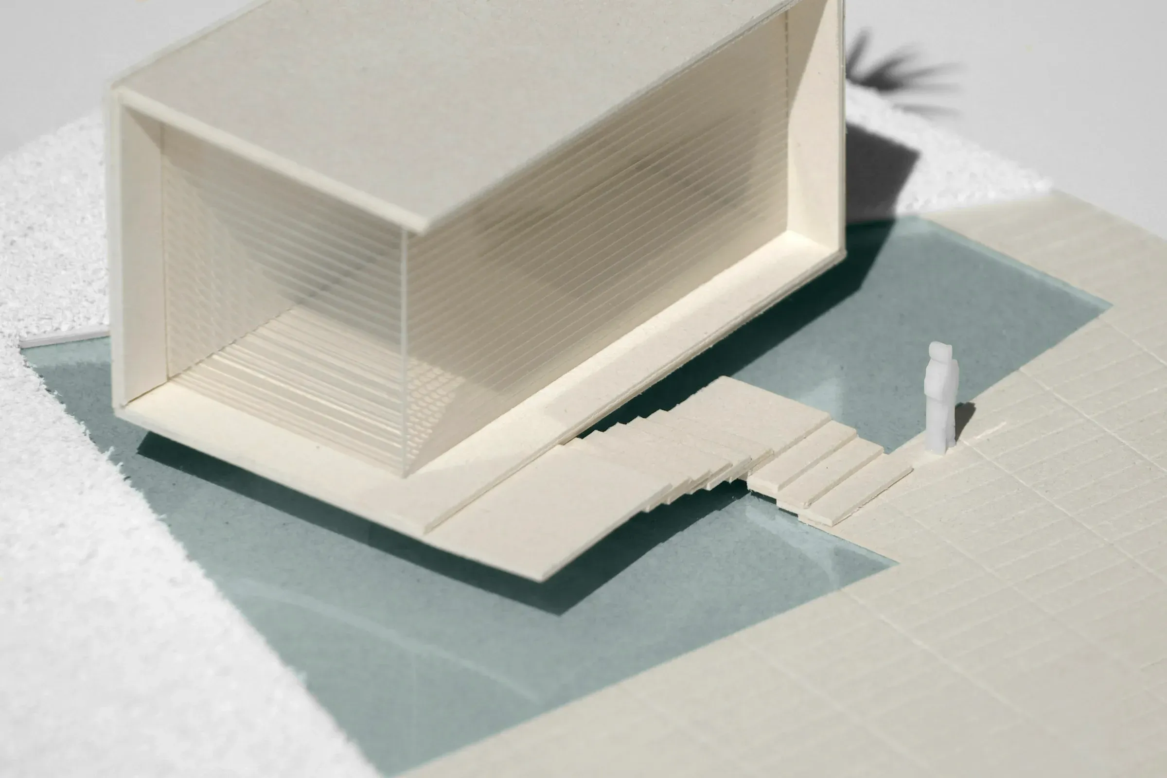 Scale model of a house resting on a studio table