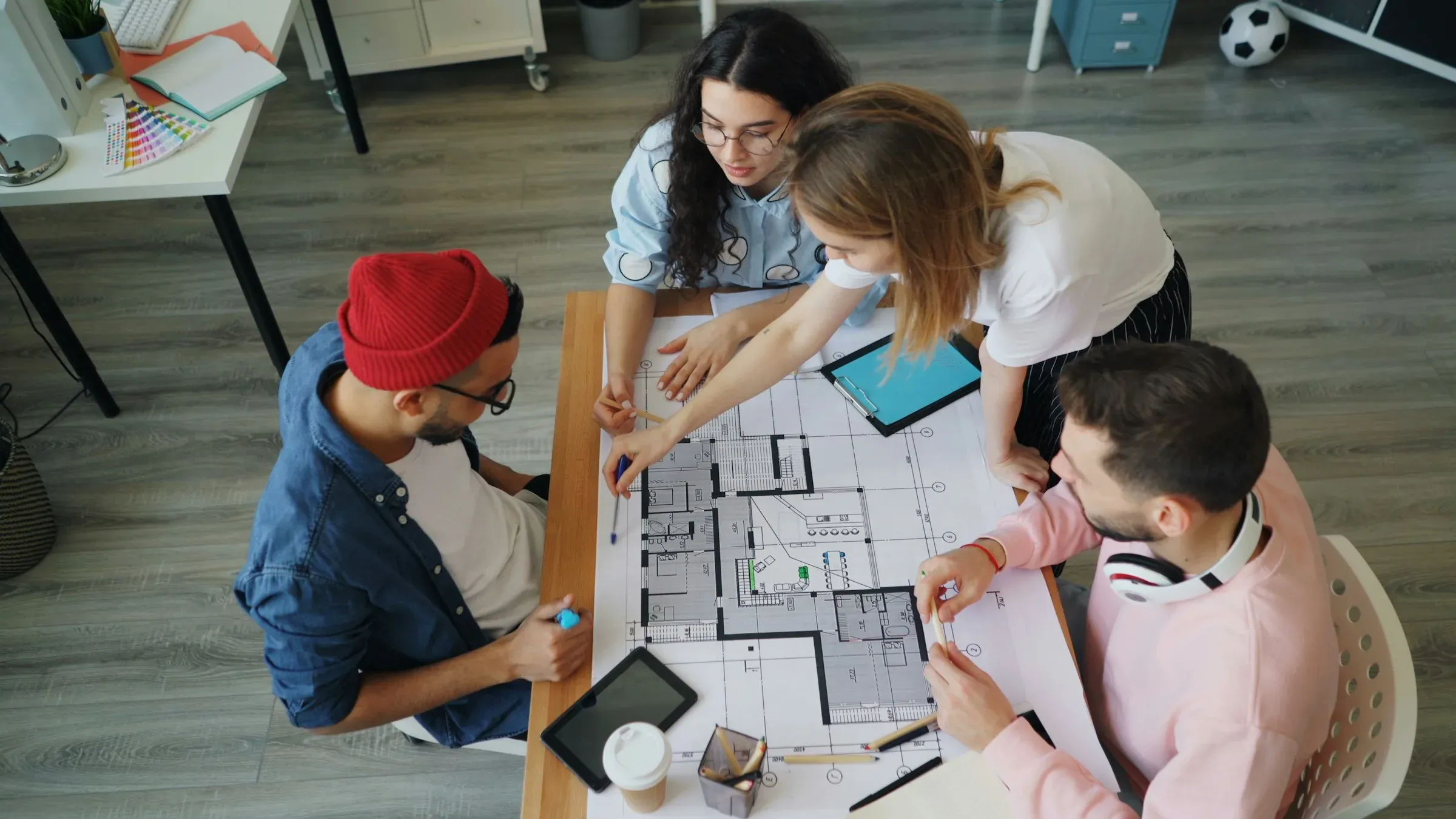 Studio team reviewing a floor plan together around a shared table