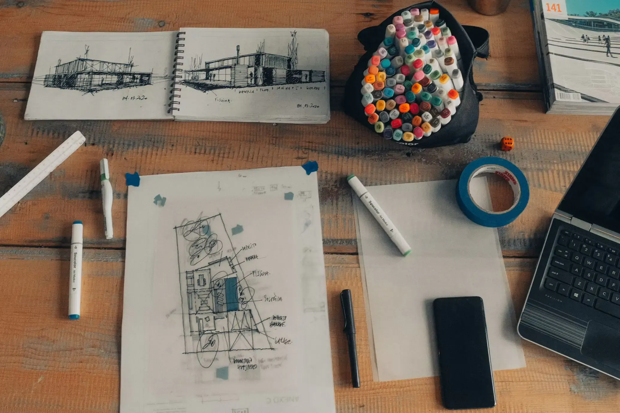 Two people reviewing architectural floor plans on a desk
