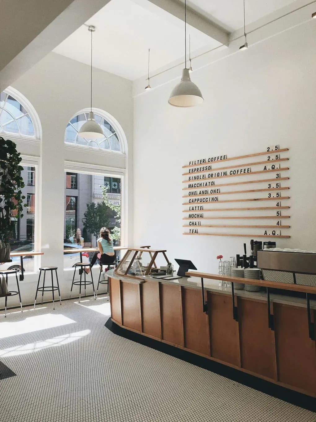 Counter and bar seating under the tall windows